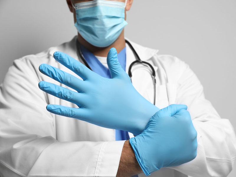 physician with mask and gloves