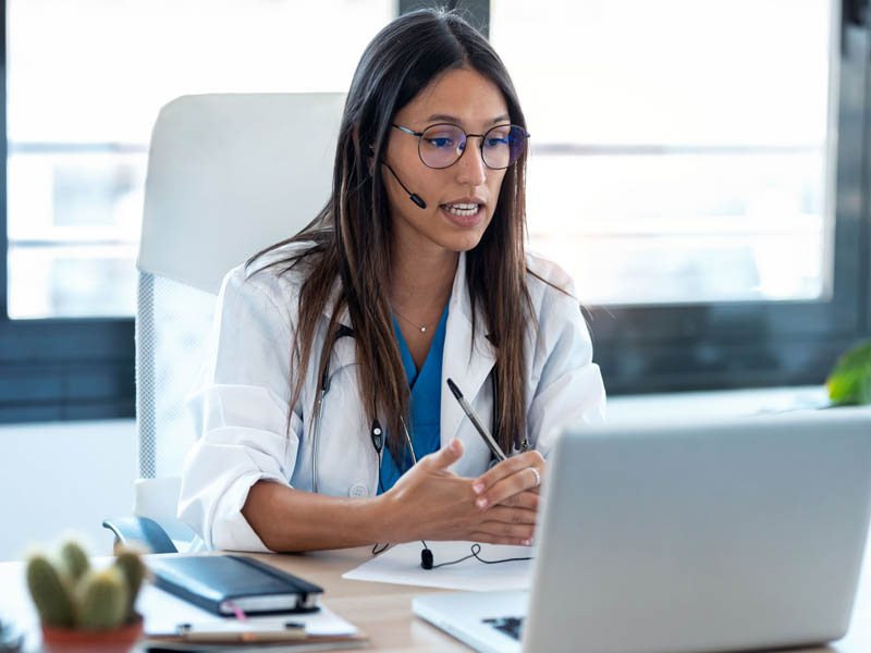 physician talking to patient on computer