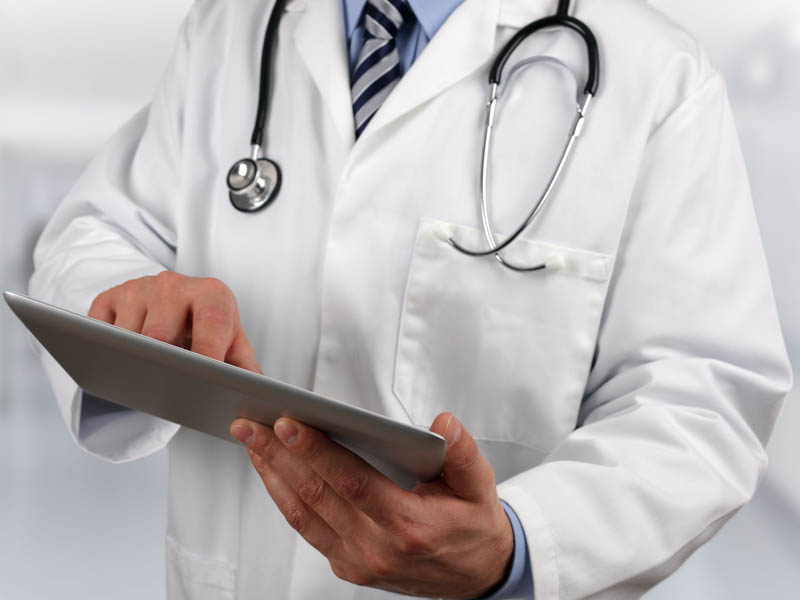 physician using tablet computer