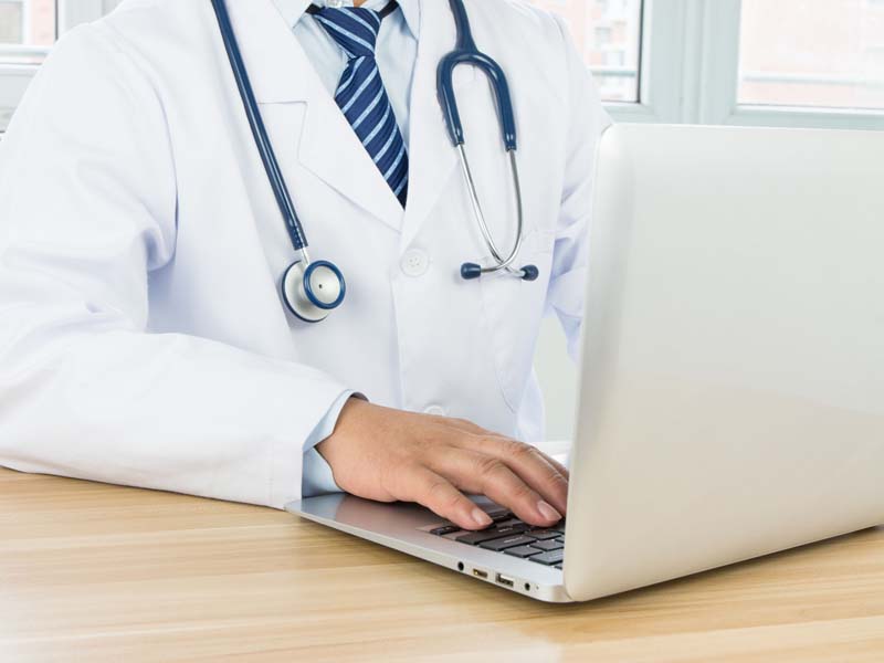 physician using laptop