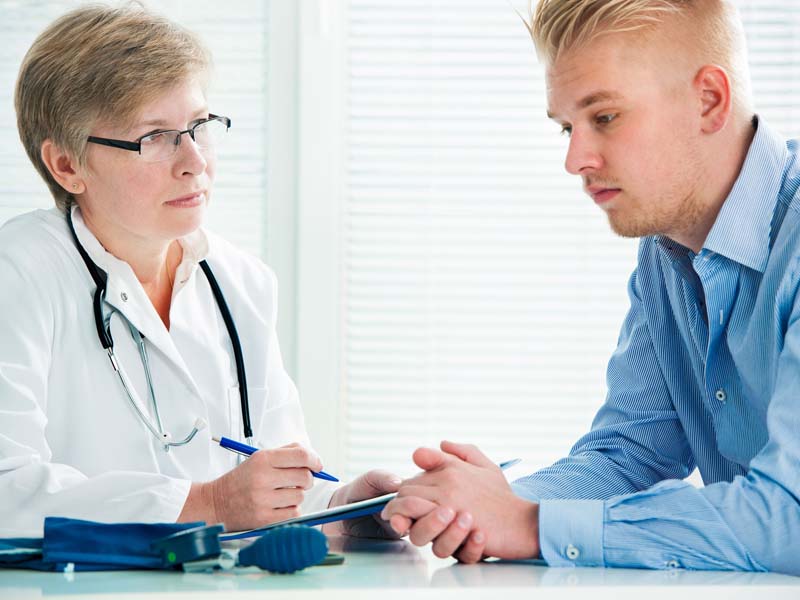 physician counseling young patient