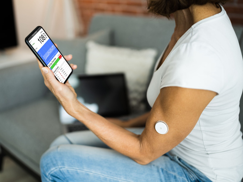 patient using continuous glucose monitor