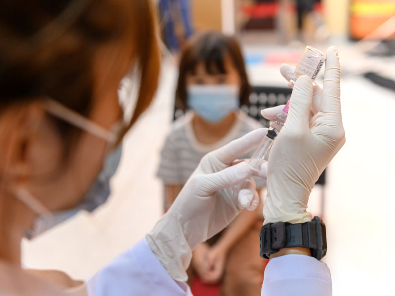physician preparing vaccine