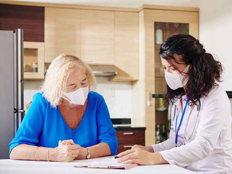 Doctor speaking to patient at patient's home