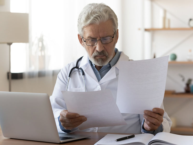 physician reviewing documents