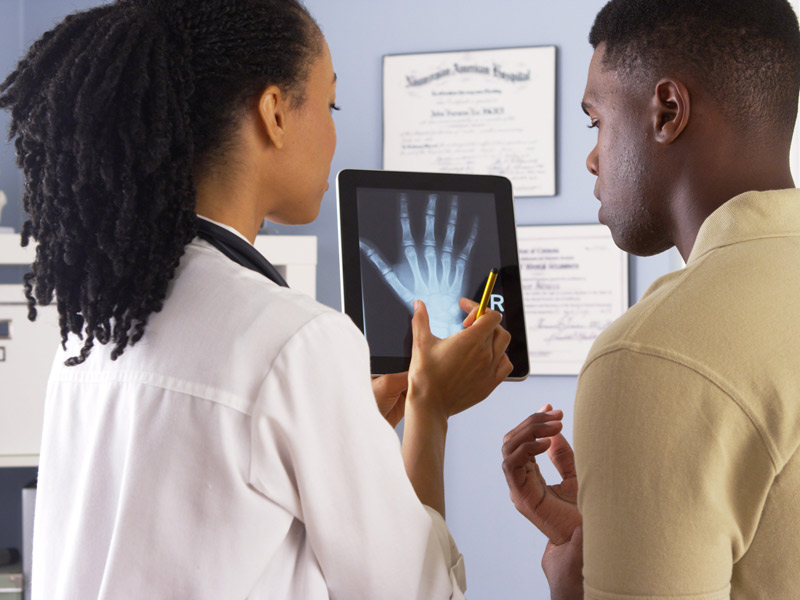female physician reviewing X-ray with patient