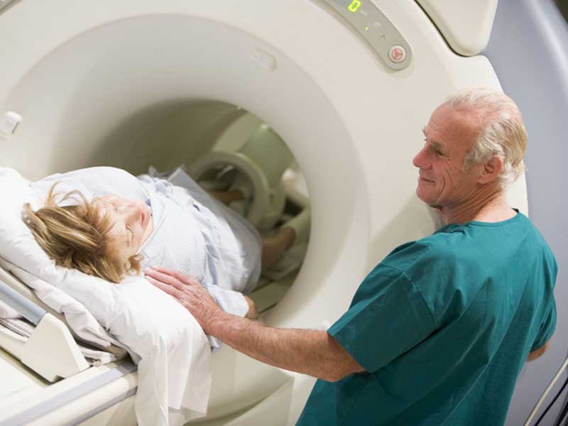 Doctor with patient for CT scan