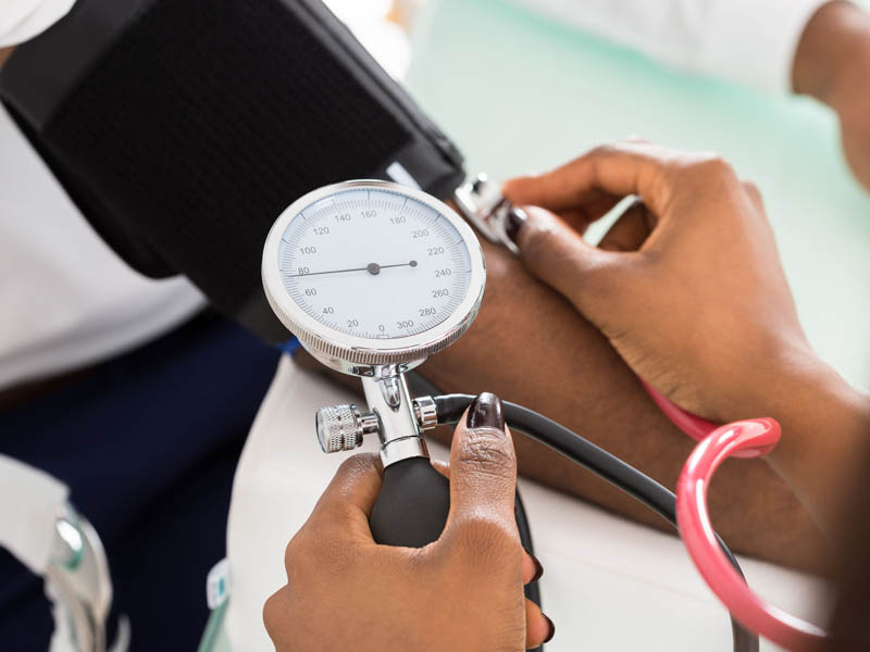physician checking blood pressure