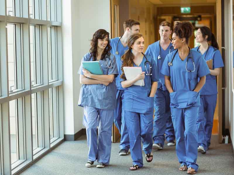 Medical students walking through corridor 
