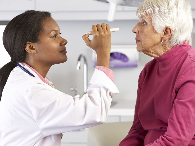 physician performing eye exam