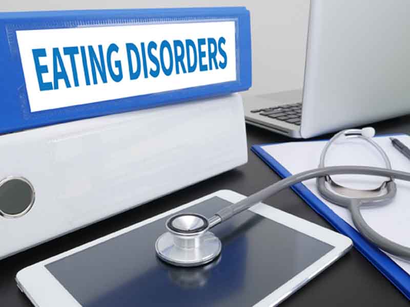 Binder labled "Eating Disorders" next to stethoscope