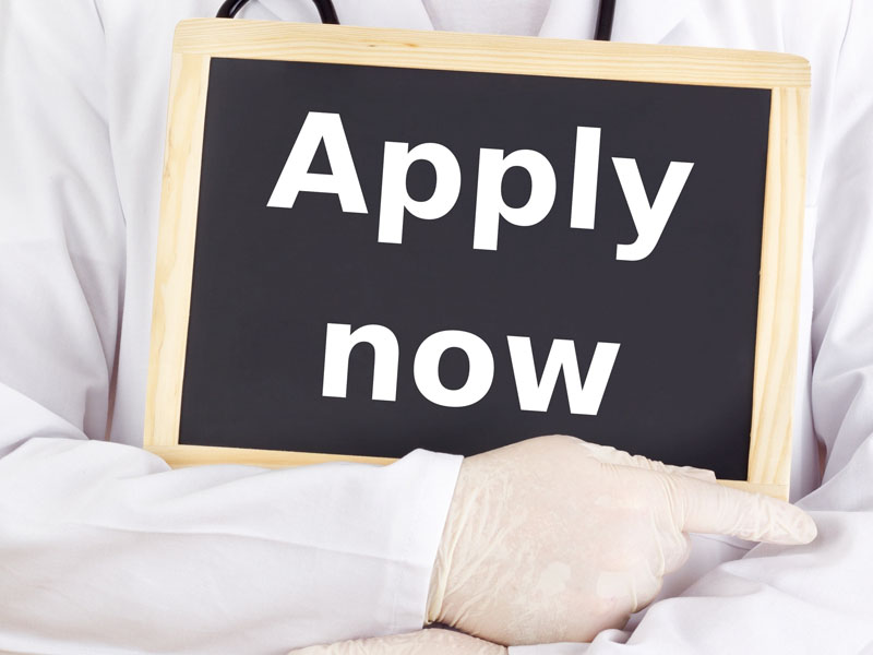 physician with apply now sign