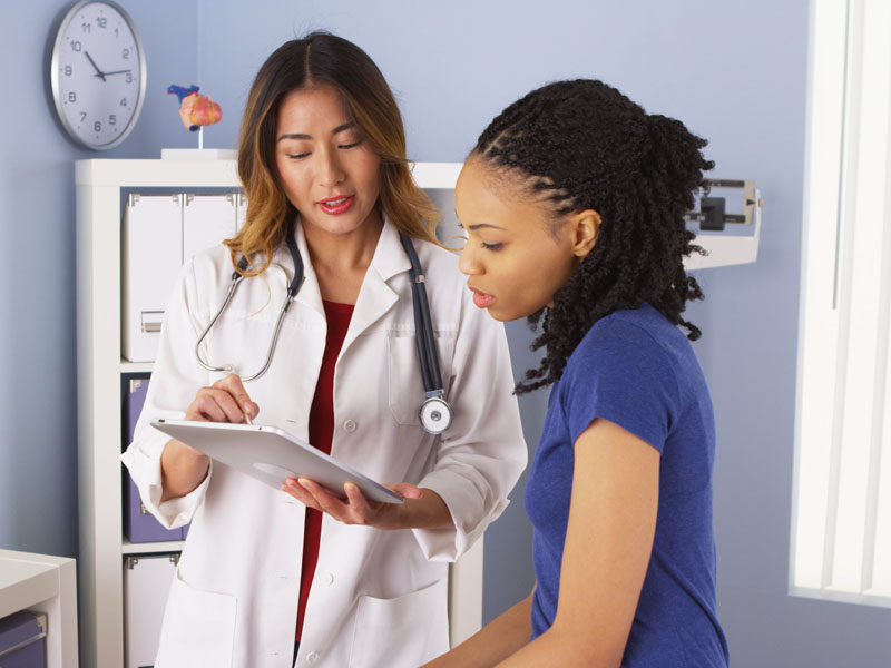 female physician speaking with female patient