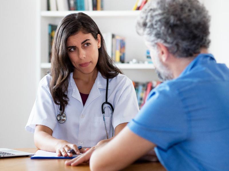Physician having a serious conversation with patient
