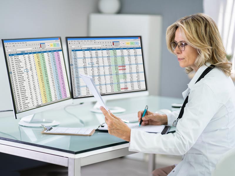physician looking at two monitors