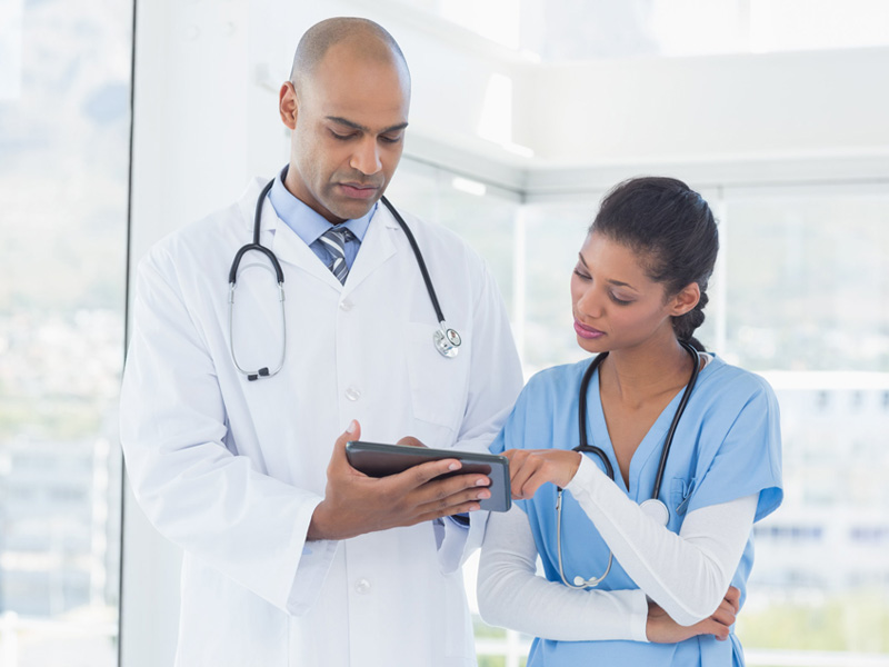 physicians looking at tablet