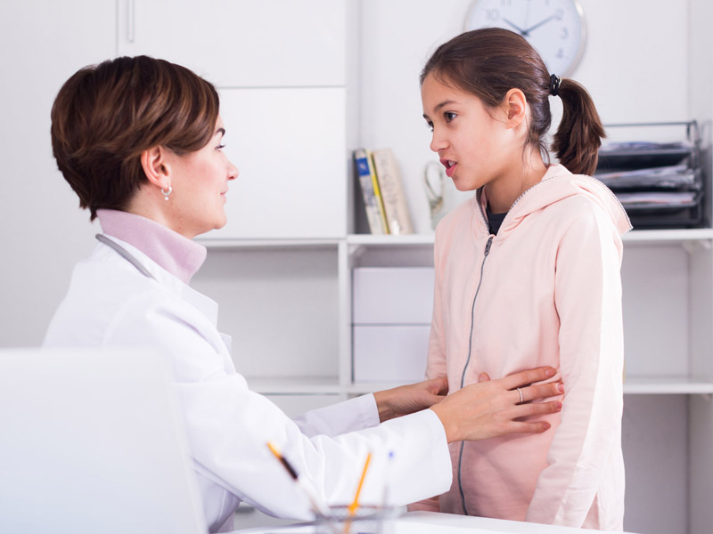 physician examines teenage girl