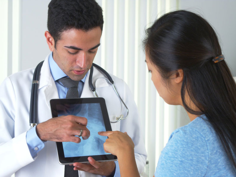 physician showing image to patient