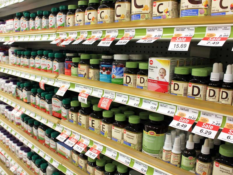 vitamin supplement bottles on grocery store shelves