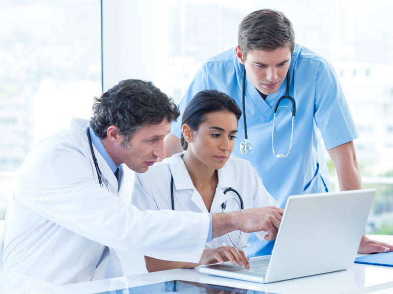 physicians using laptop