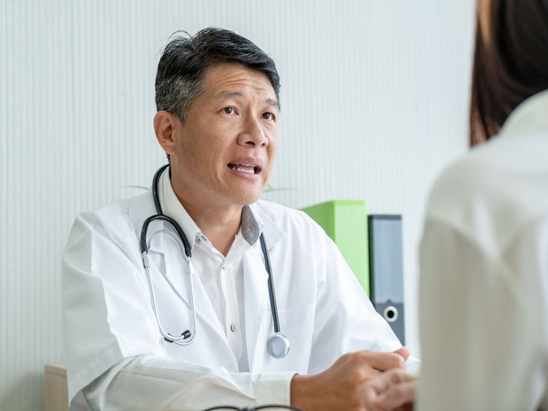 Physician talking with young patient