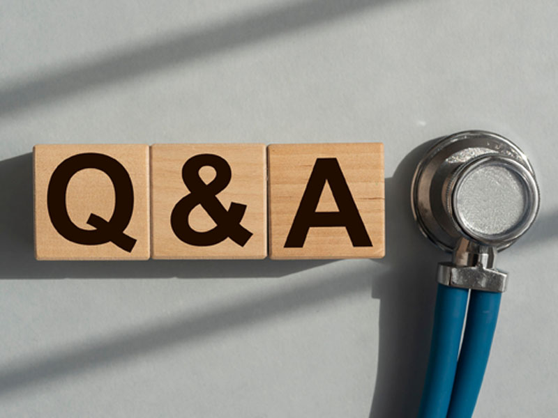 stethoscope next to three wooden squares that spell Q&A