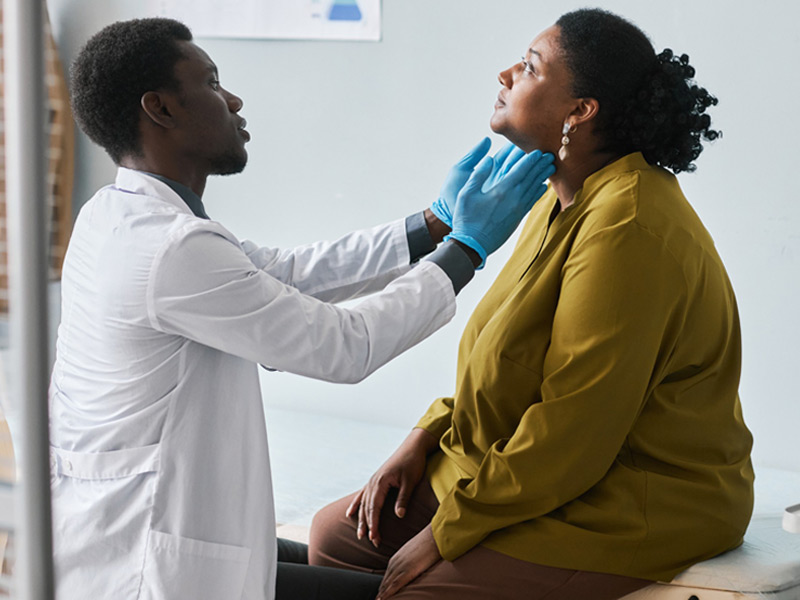Young doctor examining Black woman